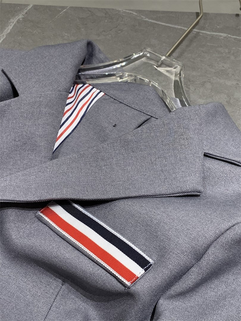 Metal-buttoned suit